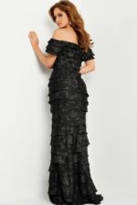 Model in Jovani 23890 showcasing elegant off-the-shoulder black dress, front view.