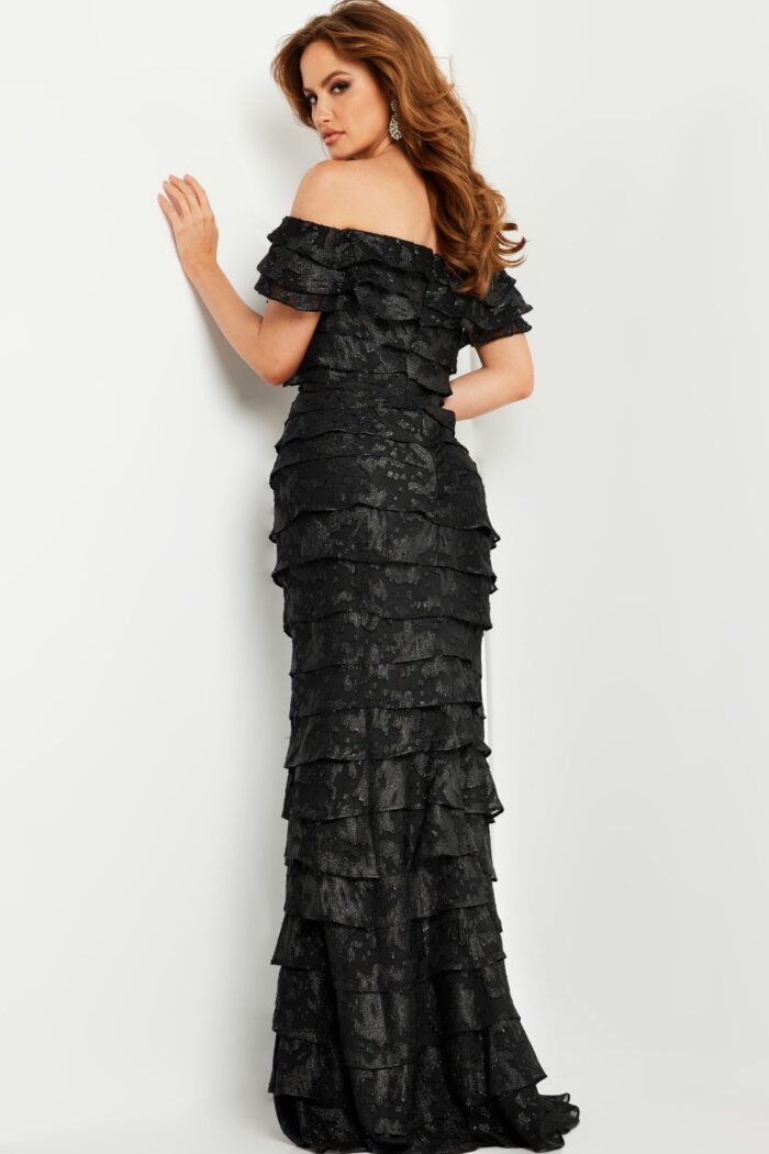 Model in Jovani 23890 showcasing elegant off-the-shoulder black dress, front view.