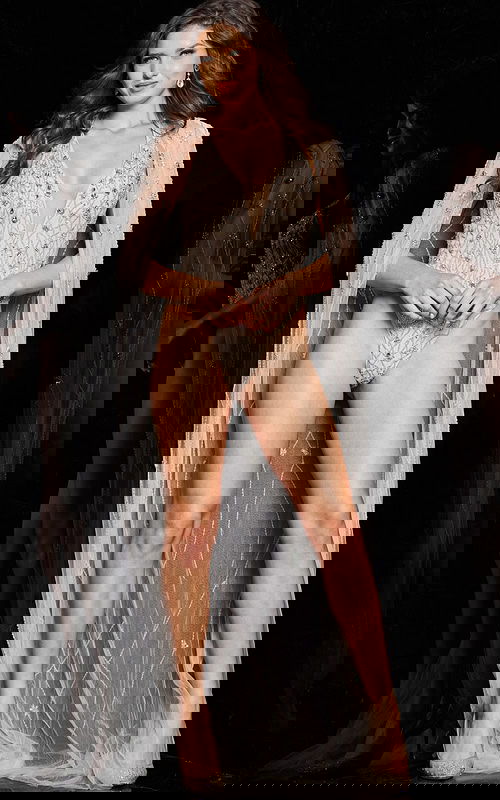 Model wearing Jovani 23895 nude dress with embellishments, front view.