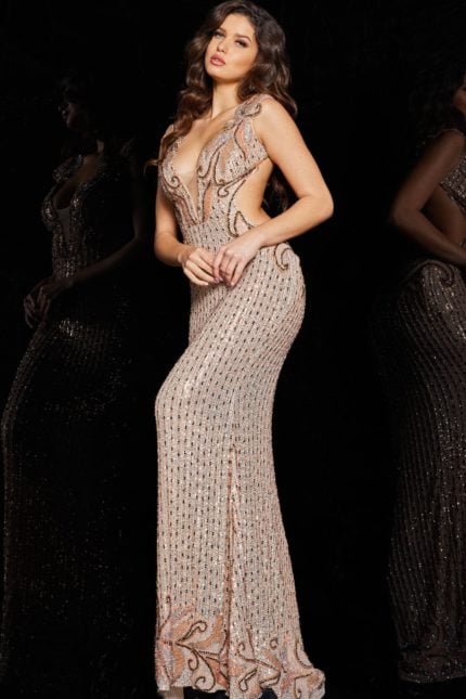 Model wearing Jovani 23896 blush dress with angled front view highlighting cutout sides.