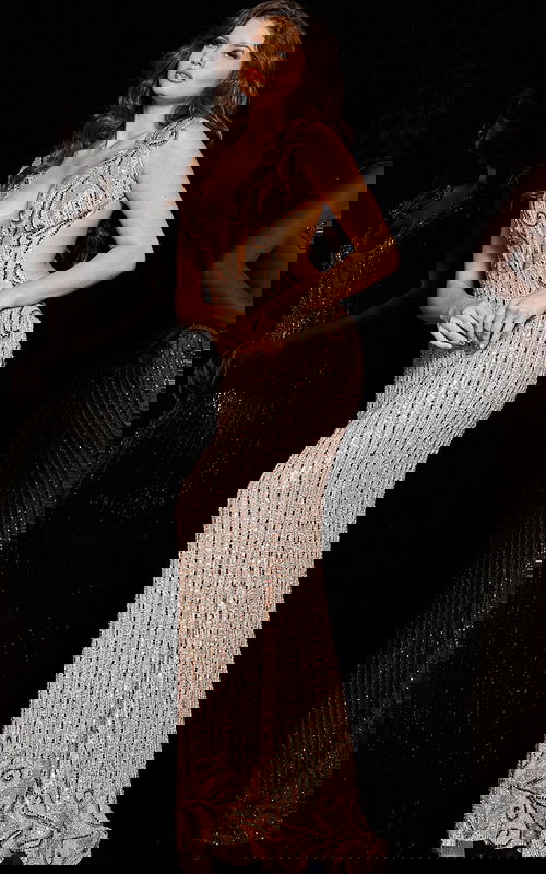 Model wearing Jovani 23896 blush dress with angled front view highlighting cutout sides.