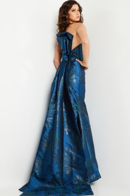 Rear view of model in Jovani 23898 navy dress highlighting the bow and train.