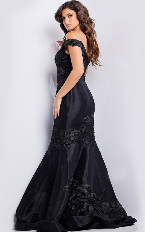 Model wearing Jovani 23928 black dress, back view showcasing mermaid silhouette.