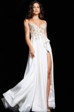 Model wearing Jovani 23937 white gown with floral embellishments and high slit.