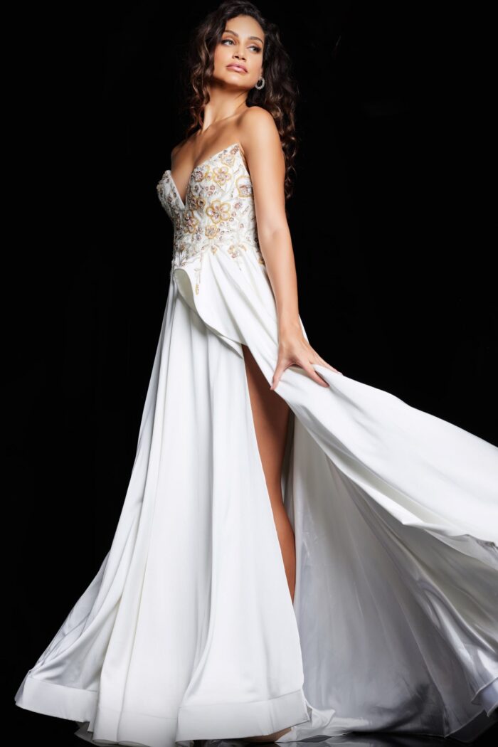 Model wearing Jovani 23937 white gown with embellished bodice and high slit.