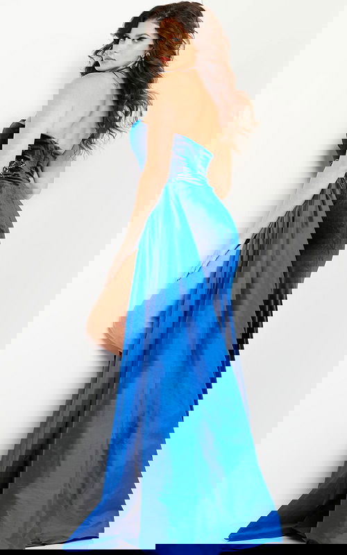 Back view of model wearing Jovani 23942 royal blue gown highlighting the cascading drape.