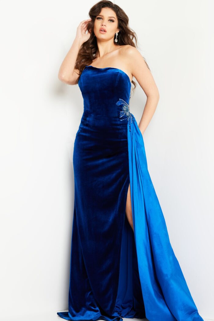 Model wearing Jovani 23942 royal blue gown with off-shoulder neckline and side slit.