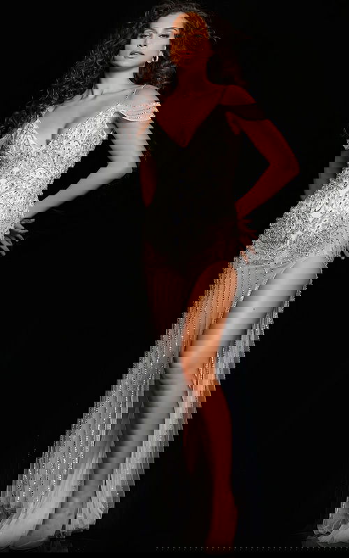 Model wearing Jovani 23961 elegant white dress front with embellishments and a high slit.