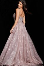 Model showcasing the back of Jovani 24001 taupe dress with detailed embellishments.
