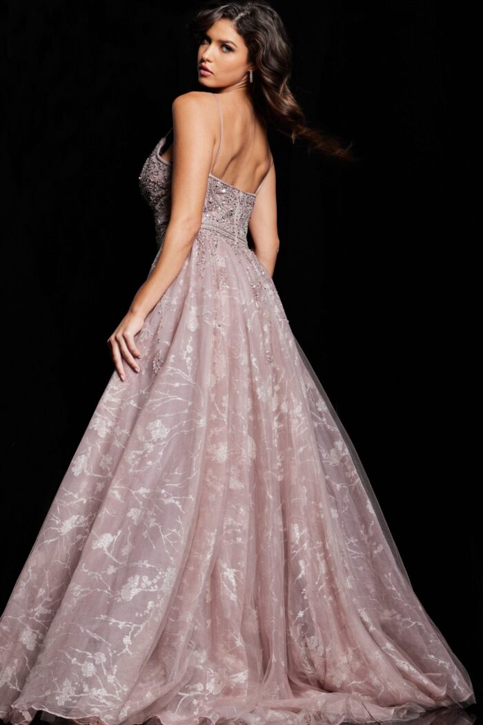Model showcasing the back of Jovani 24001 taupe dress with detailed embellishments.