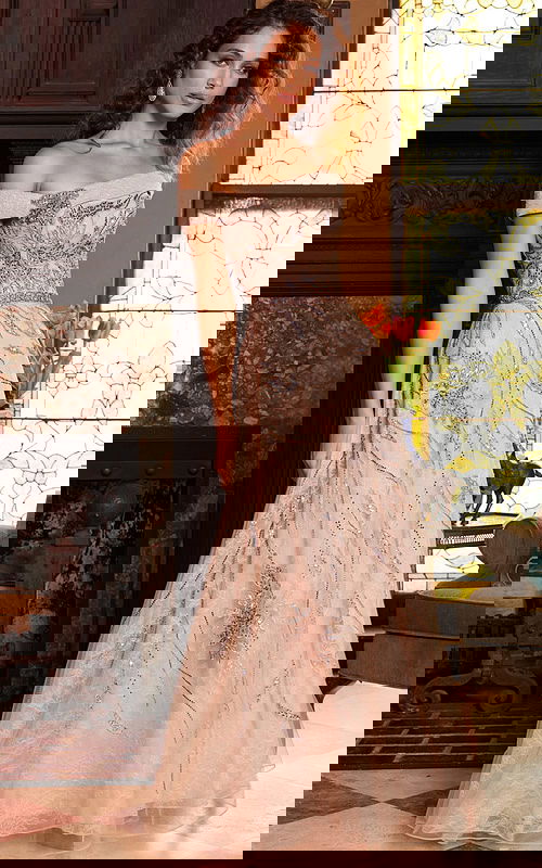 Model wearing Jovani 24055 beige floor-length dress with off-the-shoulder neckline and embroidery, front view.