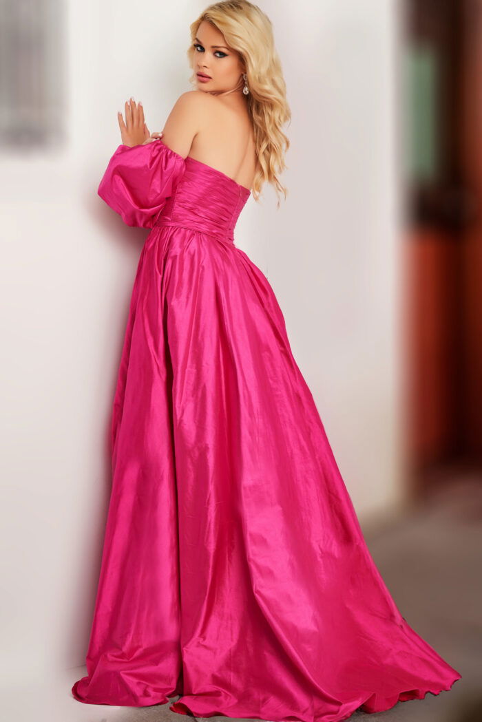 Model wearing Jovani 24099 fuchsia dress showcasing the back with puff sleeves.