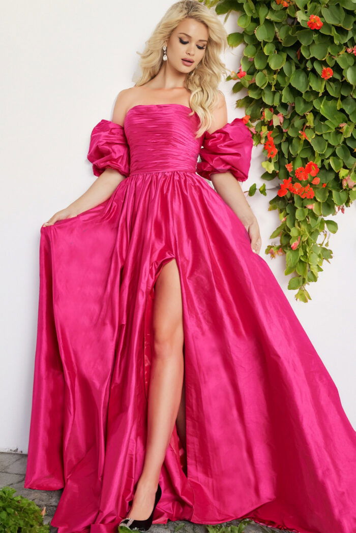 Model wearing Jovani 24099 fuchsia ballgown with off-the-shoulder neckline and high slit.