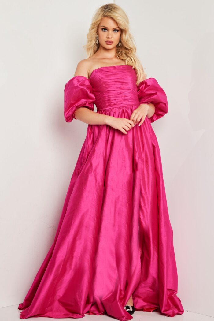 Model wearing Jovani 24099 dress showing the back with off-the-shoulder neckline and puff sleeves.