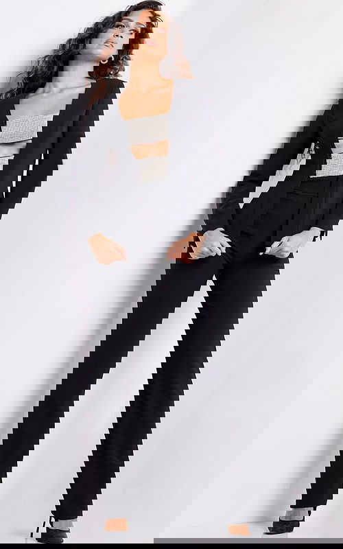 model wearing 24119 black jumpsuit with square neckline and long sleeves front view