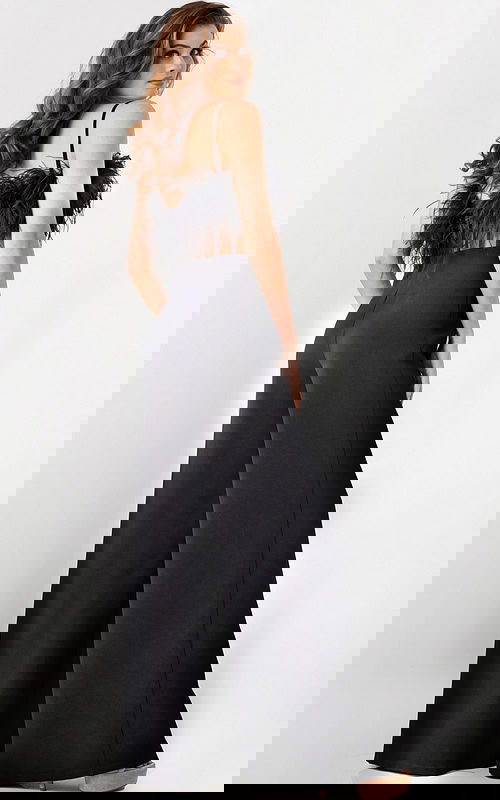 Model wearing Jovani 24144 black jumpsuit with feathered bodice, back view.