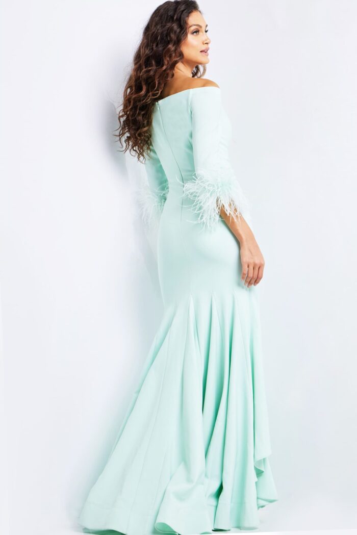 Model wearing Jovani 24195 green gown showcasing back detailing