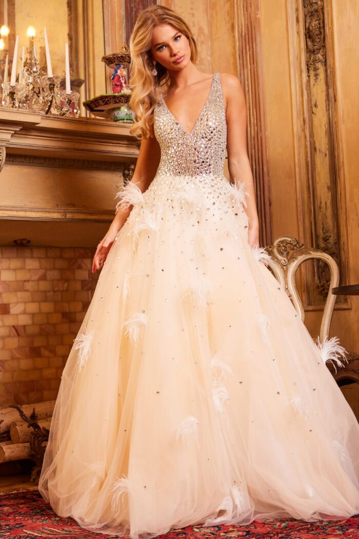 Model wearing Jovani 24255 gown with a plunging V-neckline and embellished bodice in nude.
