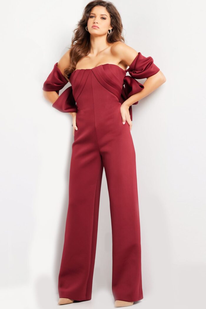 Model showcasing Jovani 24278 burgundy dress with elegant wide-leg fit.