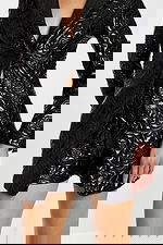 Close-up of blazer romper showing front button detail, floral embossed pattern, and matching shorts.