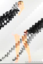 Model wearing a glossy black embossed blazer romper with long sleeves and plunging neckline, front view.