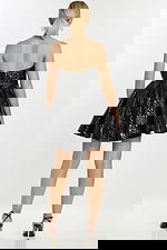 Rear angle of model in glossy black strapless cocktail dress with full A-line skirt.