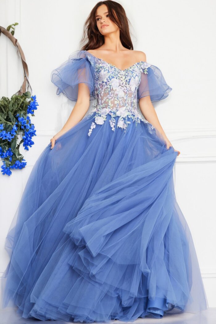 Model wearing Jovani 24575 blue gown showing off neckline and puffed sleeves.