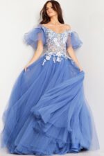 Model wearing Jovani 24575 blue ball gown with floral appliqués.