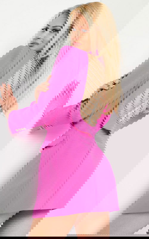 Model wearing 24619 hot pink mini dress featuring a chain detail on the back.