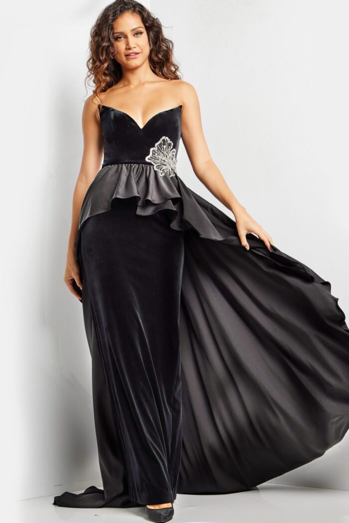 Model wearing Jovani 24631 black velvet dress with sweetheart neckline and peplum detail.