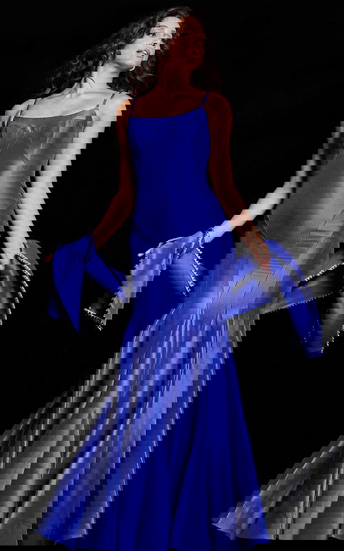 Model wearing Jovani 24642 purple gown with a square neckline and mermaid silhouette, holding an embellished shawl.