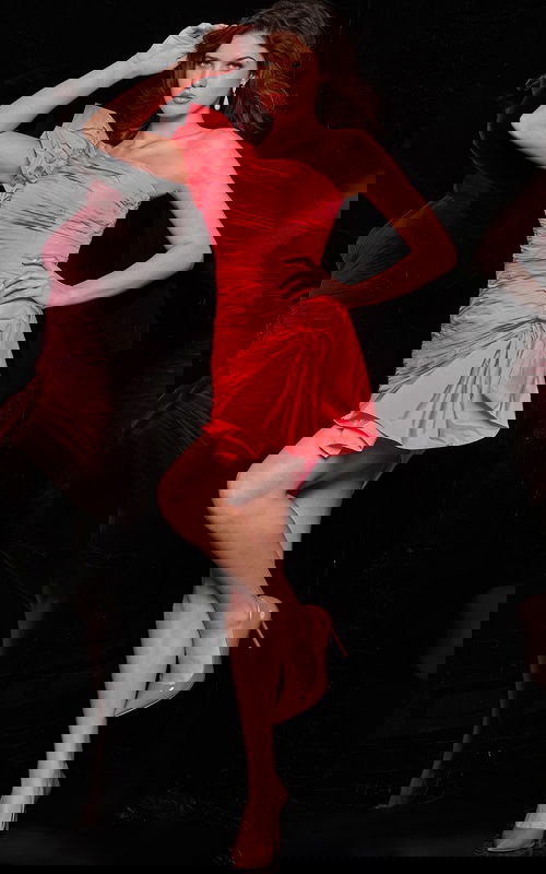 Model wearing Jovani 24647 pink mini dress with one-shoulder design and ruffles from the front.