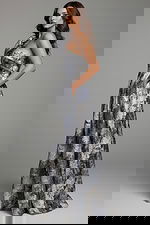 side view of model wearing Jovani 25663 dress showing off the printed pattern and one-shoulder design.