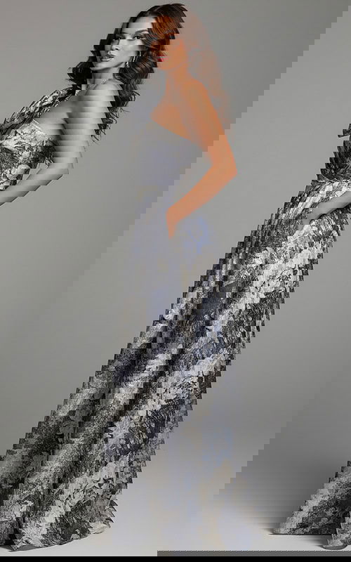 side view of model wearing Jovani 25663 dress showing off the printed pattern and one-shoulder design.