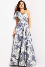 Model wearing Jovani 25663 dress featuring a printed A-line silhouette and one-shoulder neckline.