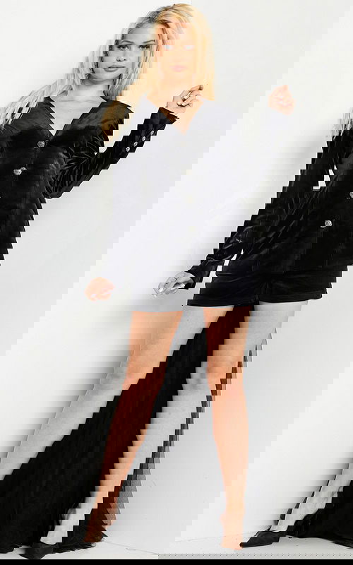 Model wearing Jovani 25741 black velvet dress with buttoned front and V-neckline.