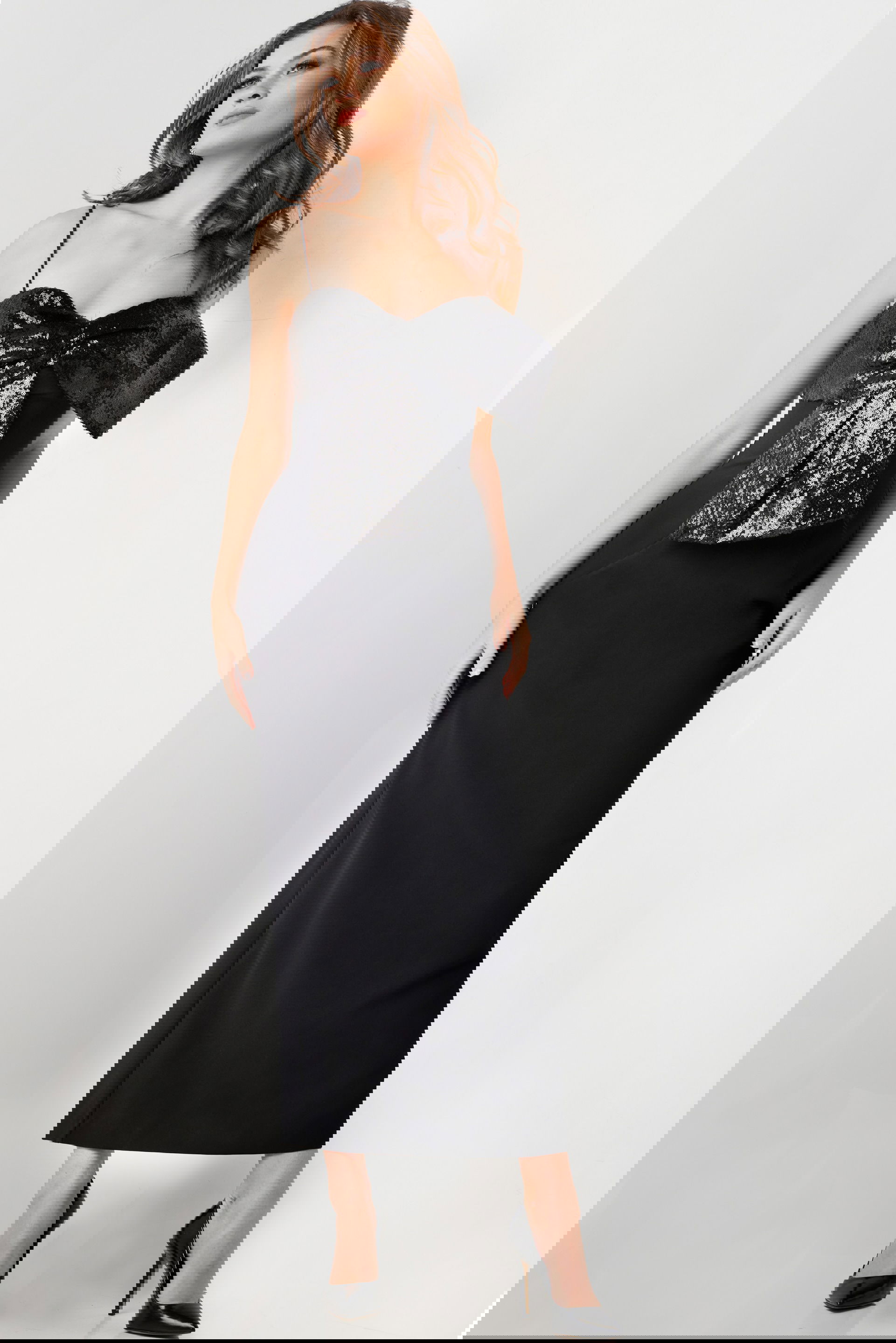 25745-BLACK-6.jpg Model wearing Jovani 25745 elegant black dress with sequin bow detail and sweetheart neckline.