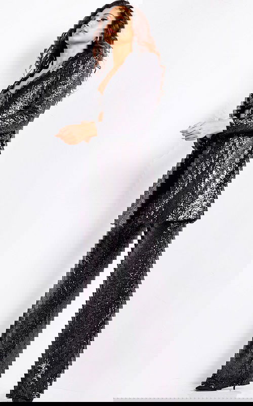 Model wearing Jovani 25749 black sequin pantsuit with blazer and wide-leg pants.