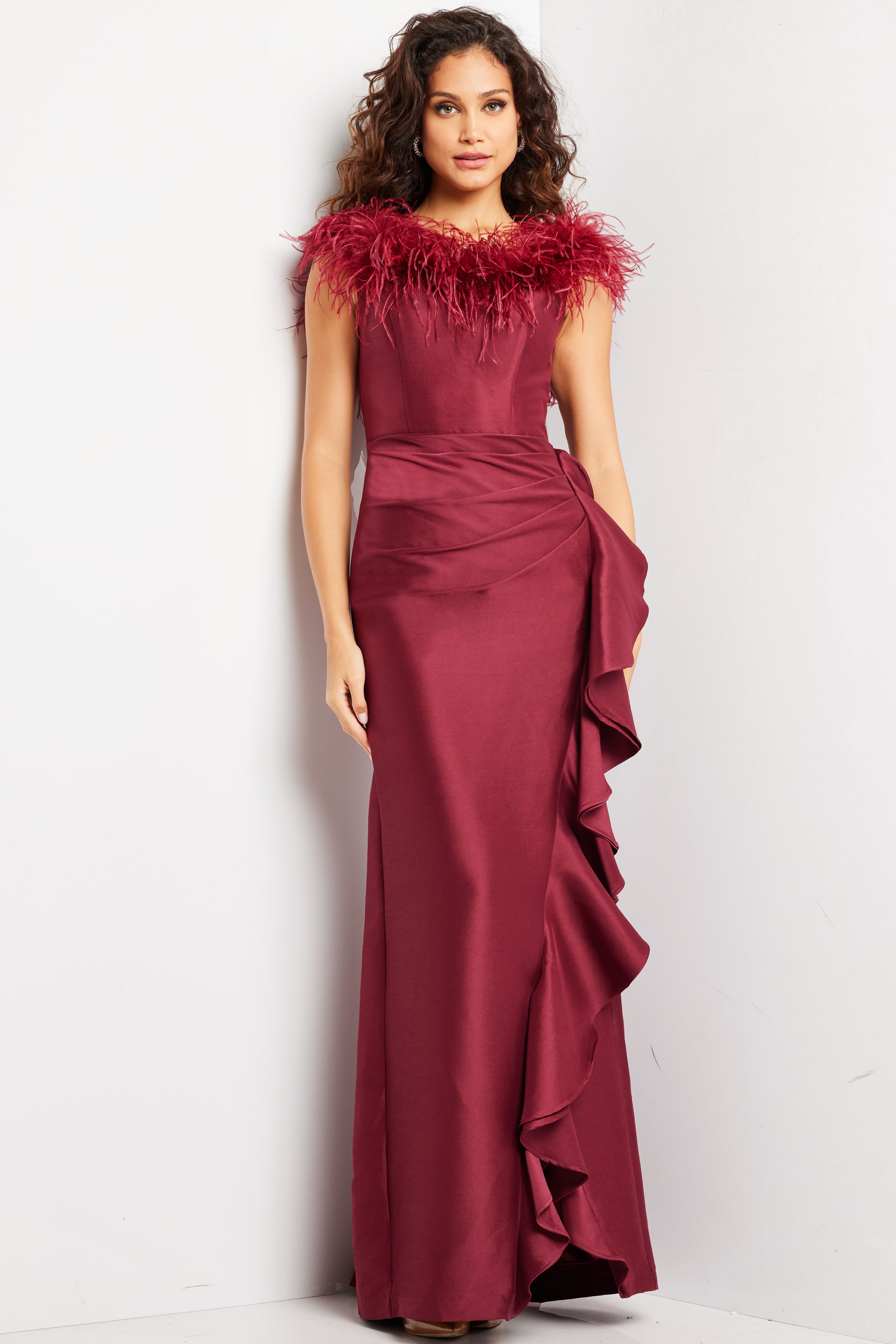 25786_BURGUNDY_2.jpg Model wearing Jovani 25786 burgundy gown with feather neckline and ruffle design, front view.