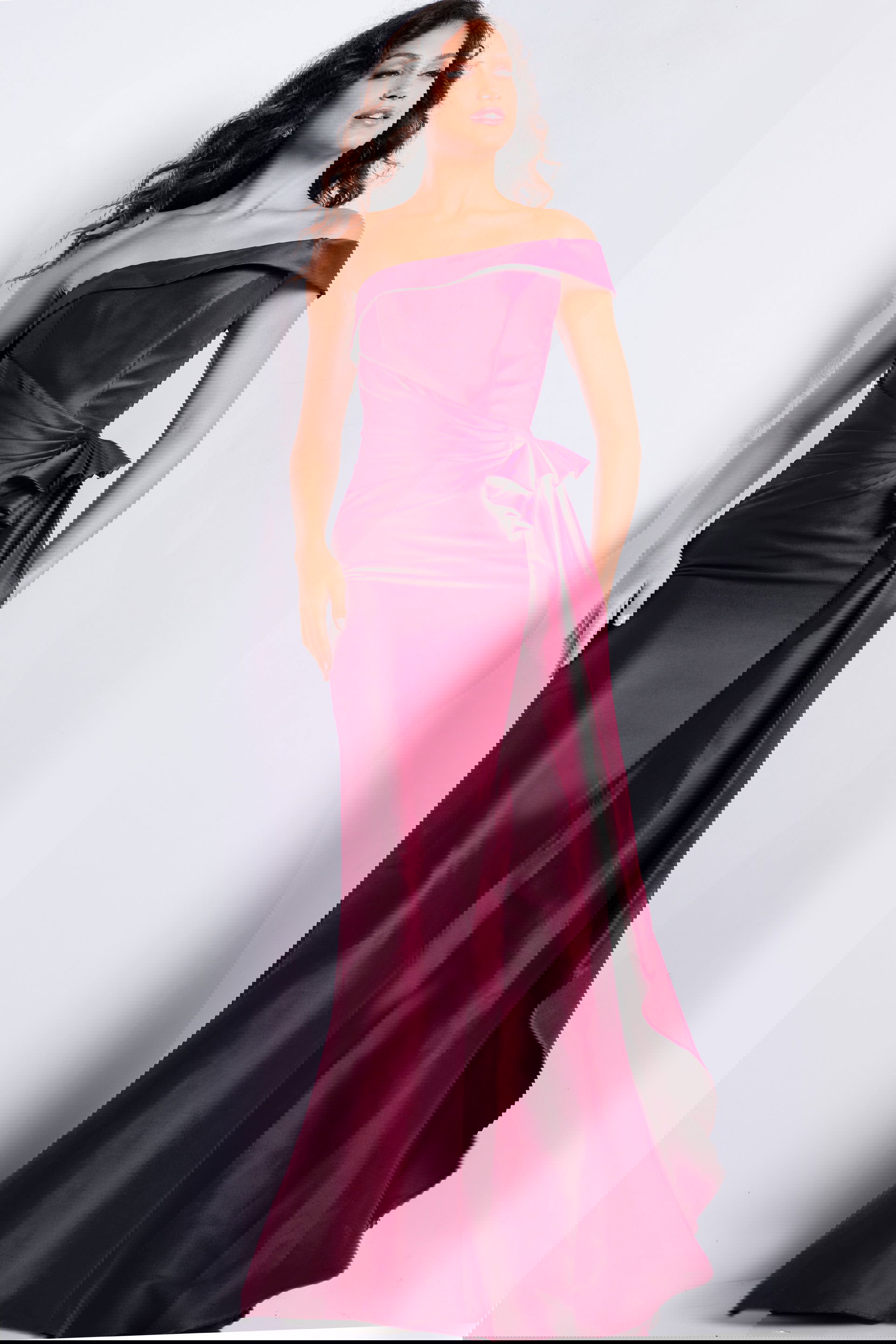 25831_BURGUNDY_2020.jpg Model wearing Jovani 25831 burgundy off-shoulder dress with floor-length design.