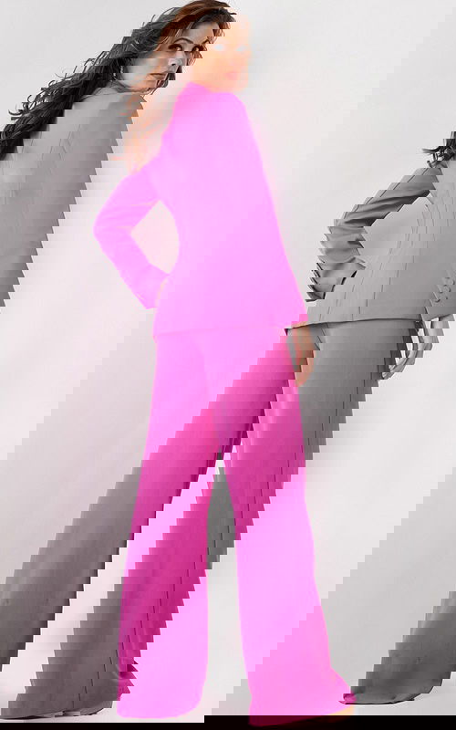 Model wearing Jovani 25834 pink blazer and wide-leg trousers, back view