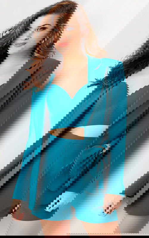 Model wearing Jovani 25840 teal blazer and shorts set with bow detail.