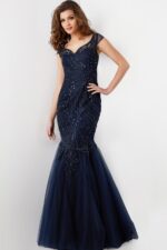Model wearing Jovani 25850 navy mermaid dress with embroidery and sequins, front view.