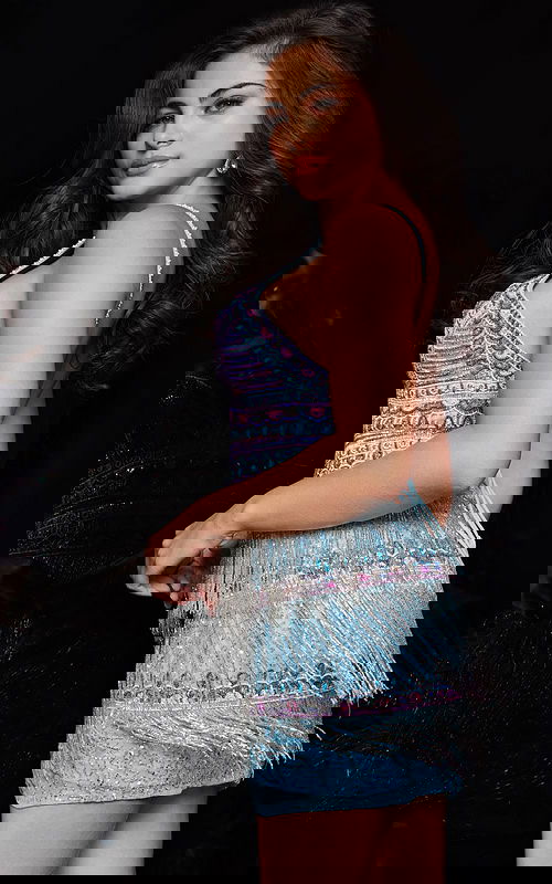 Back view of model wearing Jovani 25926 dress with stunning back design and multi-colored fringe detail.