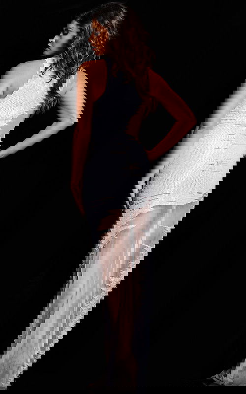 back view of model wearing Jovani 25974 white dress with sheer skirt