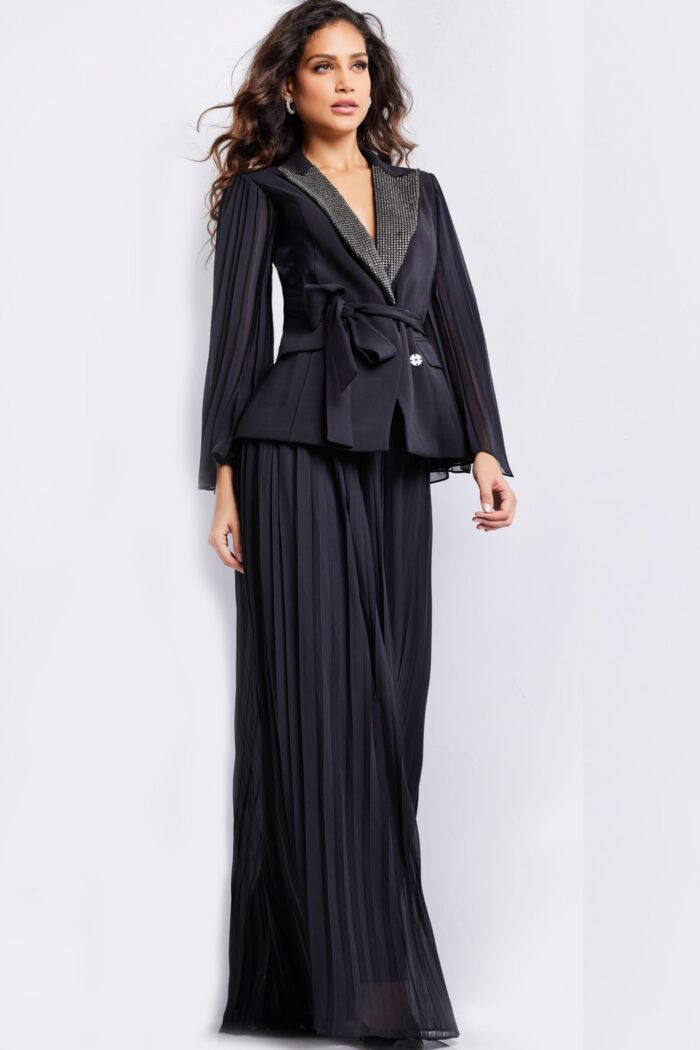 Front view of model in Jovani 26024 black gown with beaded lapel and belt.
