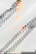 Side view of silver sequin three-piece outfit with sparkling flare pants and open jacket.