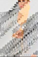 Close-up of sequin blazer and bandeau top with metallic ring detail at the bust.