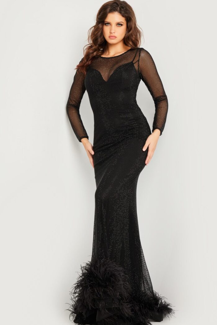 Model wearing Jovani 26047 elegant black gown with illusion neckline and fringe hem.