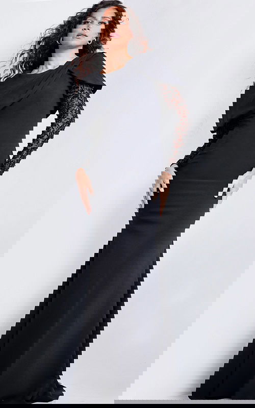 Model wearing Jovani 26062 elegant black floor-length dress with lace sleeves and unique neckline.